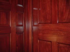 One of the doors was previously painted and Faux-Grained to match the other natural Mahogany door – can you tell which one?